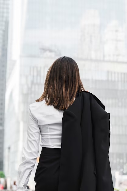 A woman in business suit walking on the street
